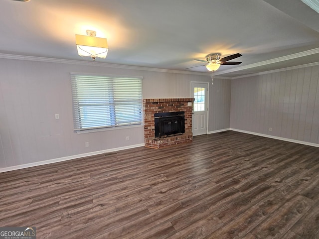 unfurnished living room featuring visible vents, ornamental molding, a ceiling fan, and dark wood finished floors