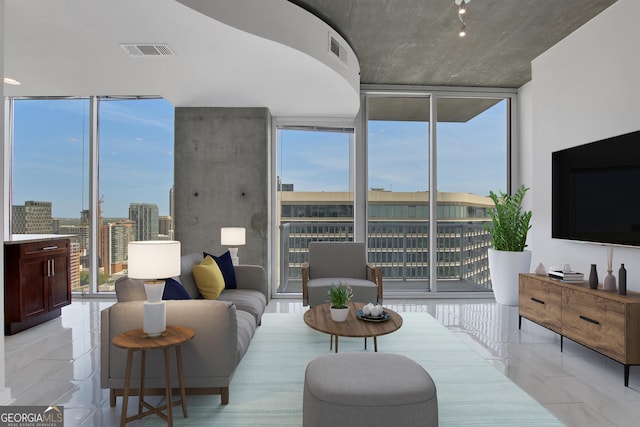 living area with visible vents, a view of city, and floor to ceiling windows