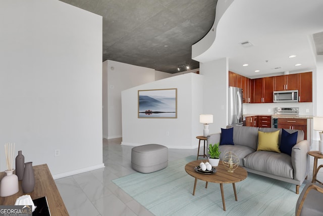 kitchen with appliances with stainless steel finishes, marble finish floor, baseboards, and visible vents