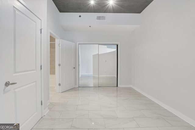 unfurnished bedroom featuring visible vents, marble finish floor, and baseboards