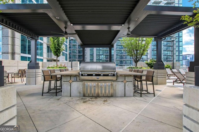 view of patio with grilling area, exterior kitchen, and outdoor wet bar