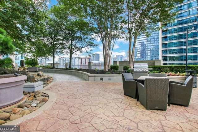 view of patio / terrace with a grill and a view of city