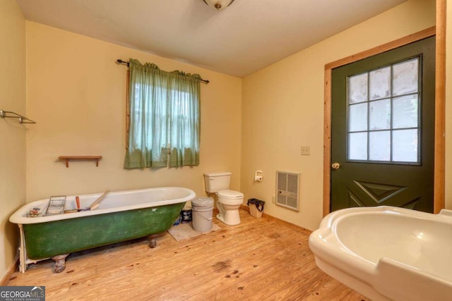 2479 Plum Orchard Rd Unit 1 & 2, Clayton, GA 30525 - full bath with heating unit, a freestanding bath, and wood finished floors