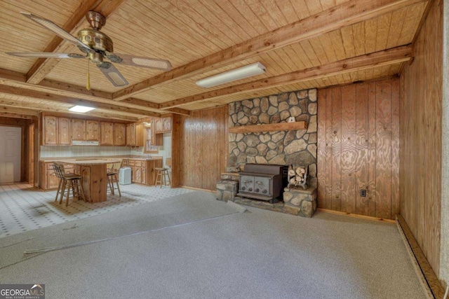 2479 Plum Orchard Rd Unit 1 & 2, Clayton, GA 30525 - unfurnished dining area featuring a wooden ceiling with exposed beams, a wood stove, wooden walls, light colored carpet, and ceiling fan