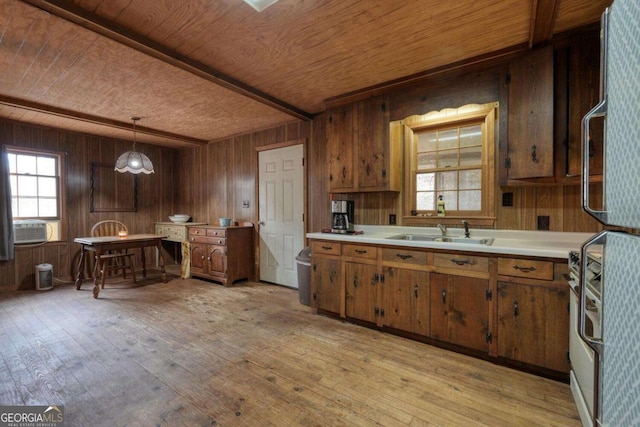 2479 Plum Orchard Rd Unit 1 & 2, Clayton, GA 30525 - kitchen with a wood ceiling with exposed beams, brown cabinets, wood walls, light wood-style flooring, and light countertops