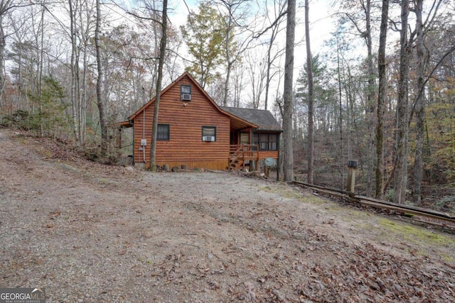 2479 Plum Orchard Rd Unit 1 & 2, Clayton, GA 30525 - view of home's exterior featuring driveway, faux log siding, and a wooded view