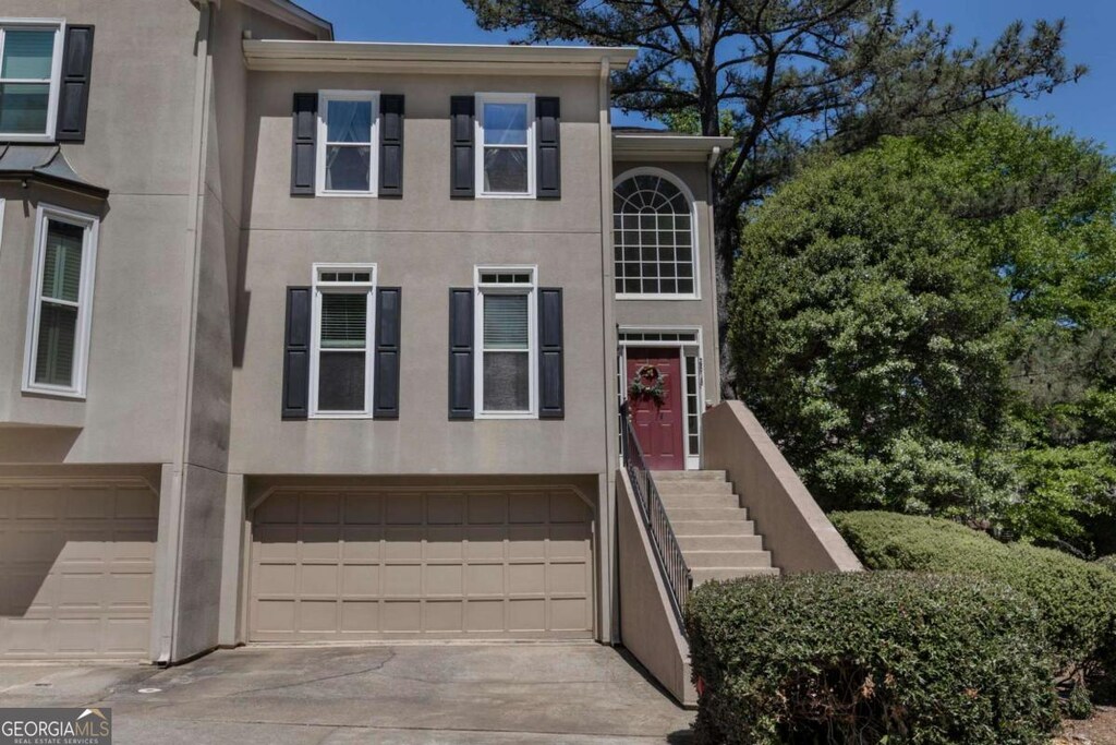 2518 Oakwood Way SE, Smyrna, GA 30080 - multi unit property featuring concrete driveway, an attached garage, and stucco siding