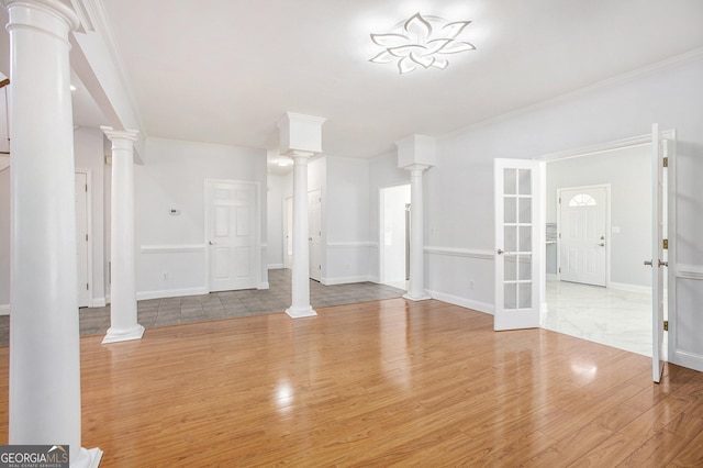 4505 Lakefield Bnd, Berkeley Lake, GA 30096 - unfurnished living room with wood finished floors, decorative columns, and crown molding