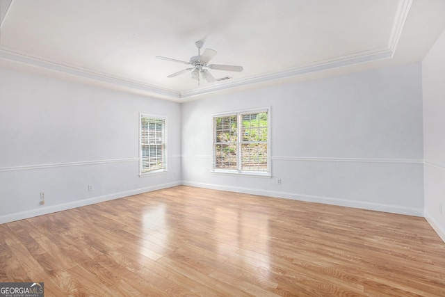 4505 Lakefield Bnd, Berkeley Lake, GA 30096 - spare room with a tray ceiling, a ceiling fan, light wood-style floors, and crown molding