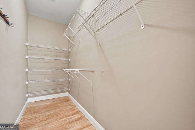 spacious closet with wood finished floors