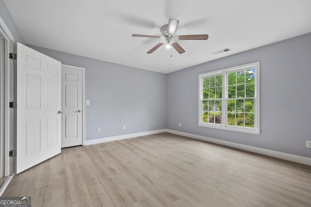 unfurnished bedroom featuring wood finished floors, baseboards, and ceiling fan
