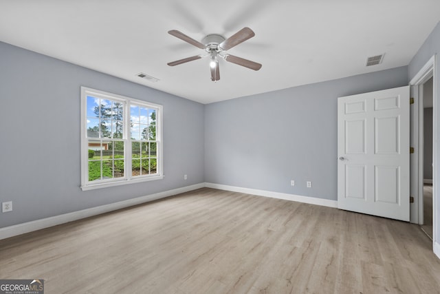 unfurnished bedroom with light wood-style flooring, baseboards, and a ceiling fan