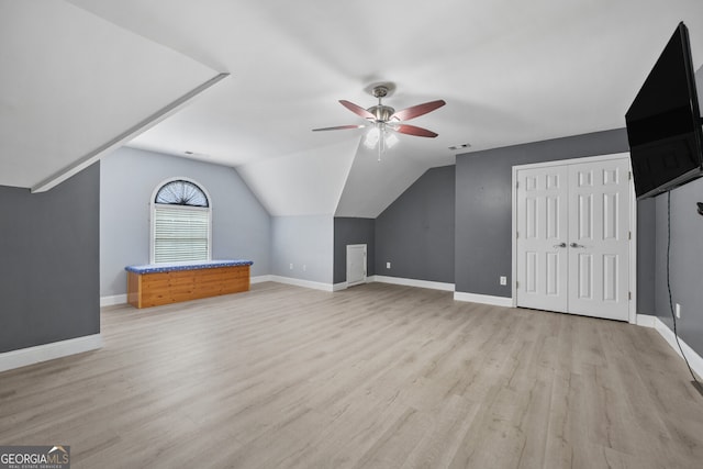 additional living space featuring ceiling fan, light wood-type flooring, baseboards, and lofted ceiling