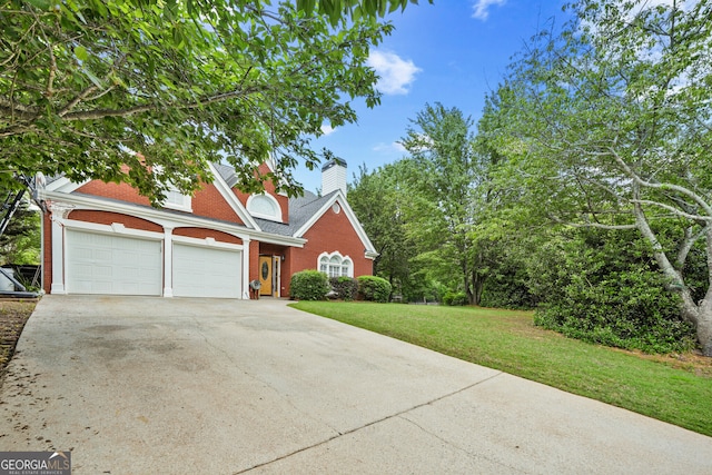view of front of house featuring concrete driveway, brick siding, a garage, a front yard, and a chimney