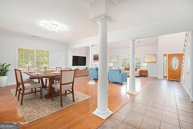 4505 Lakefield Bnd, Berkeley Lake, GA 30096 - dining room with decorative columns, ornamental molding, healthy amount of natural light, and light wood-type flooring