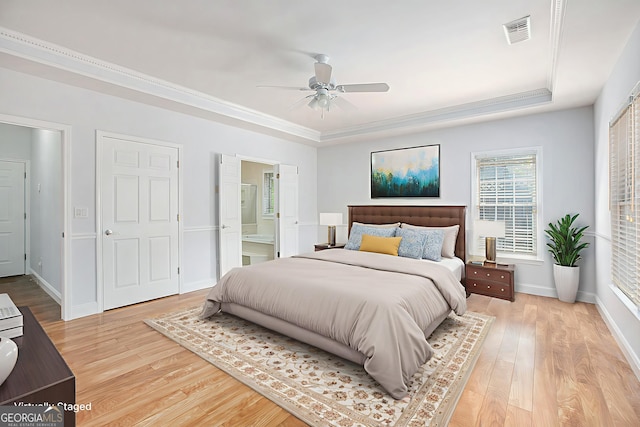 4505 Lakefield Bnd, Berkeley Lake, GA 30096 - bedroom with a tray ceiling, light wood-type flooring, ensuite bathroom, crown molding, and ceiling fan