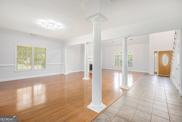 4505 Lakefield Bnd, Berkeley Lake, GA 30096 - unfurnished living room with decorative columns, healthy amount of natural light, light wood-style floors, and ornamental molding
