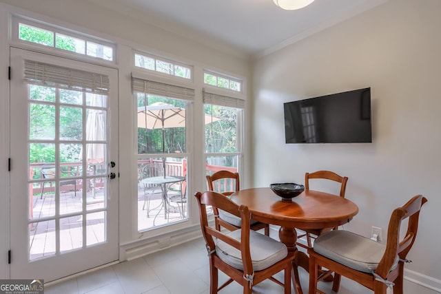 dining room featuring ornamental molding and light tile patterned floors