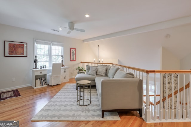 living room with a ceiling fan, wood finished floors, baseboards, a chandelier, and recessed lighting