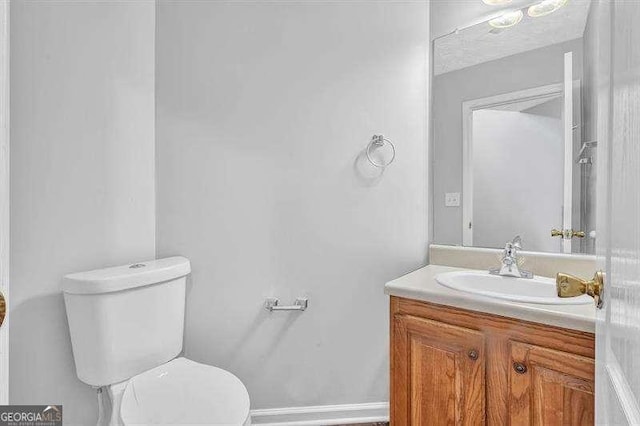 bathroom with toilet and vanity