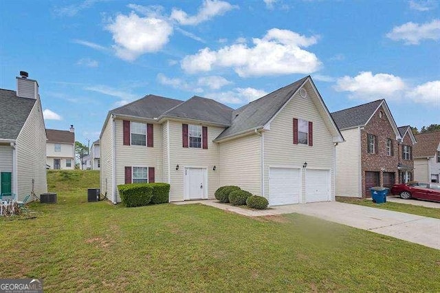 view of front of house with a front yard, driveway, and a garage