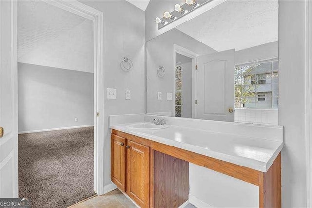 bathroom with vanity and baseboards