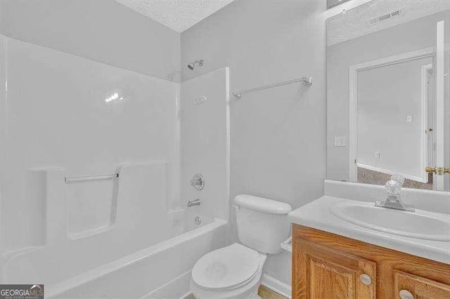 bathroom with a textured ceiling, vanity, visible vents, toilet, and shower / bathing tub combination