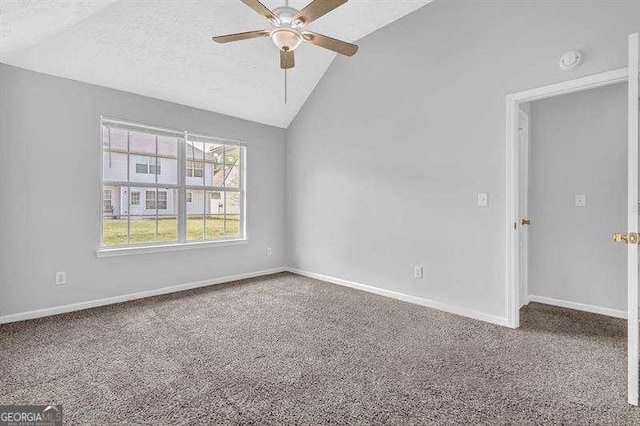 carpeted empty room with a textured ceiling, ceiling fan, baseboards, and lofted ceiling