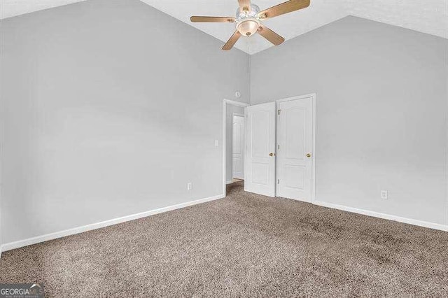 unfurnished room with baseboards, a ceiling fan, carpet flooring, and high vaulted ceiling