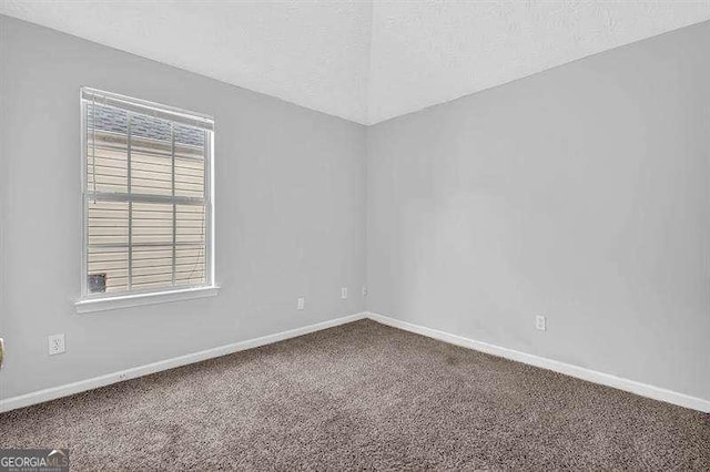 carpeted empty room with baseboards
