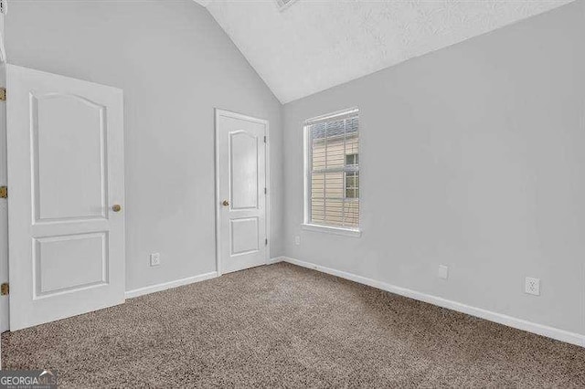 unfurnished bedroom with baseboards, vaulted ceiling, and carpet floors