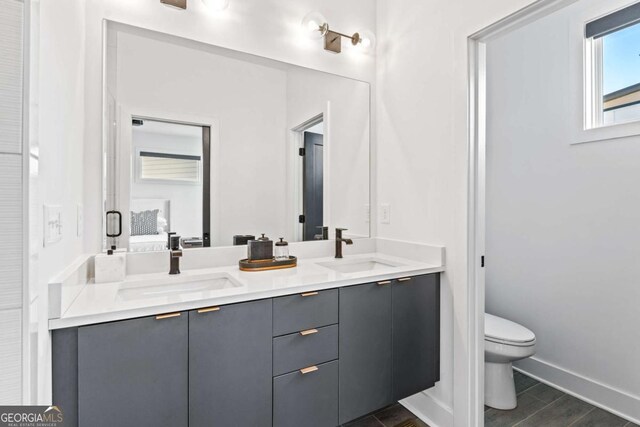 2424 Memorial Dr SE Unit 3, Atlanta, GA 30317 - bathroom featuring toilet, double vanity, a sink, and baseboards