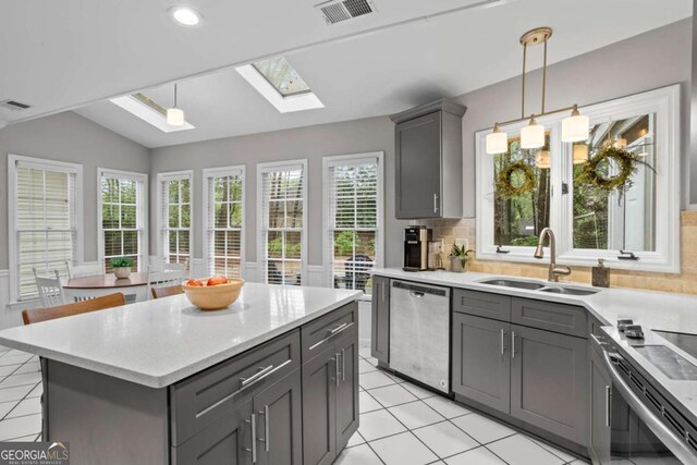 5663 Brookstone Dr NW, Acworth, GA 30101 - kitchen with stainless steel appliances, a sink, lofted ceiling with skylight, visible vents, and gray cabinetry