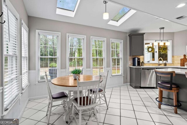 5663 Brookstone Dr NW, Acworth, GA 30101 - dining room with a skylight, wainscoting, visible vents, and light tile patterned floors