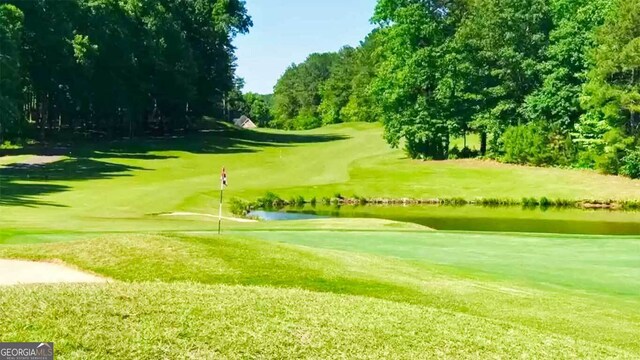 5663 Brookstone Dr NW, Acworth, GA 30101 - view of home's community featuring a lawn, a water view, and view of golf course