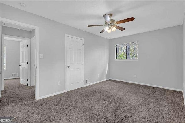 unfurnished bedroom with carpet floors, baseboards, and a ceiling fan