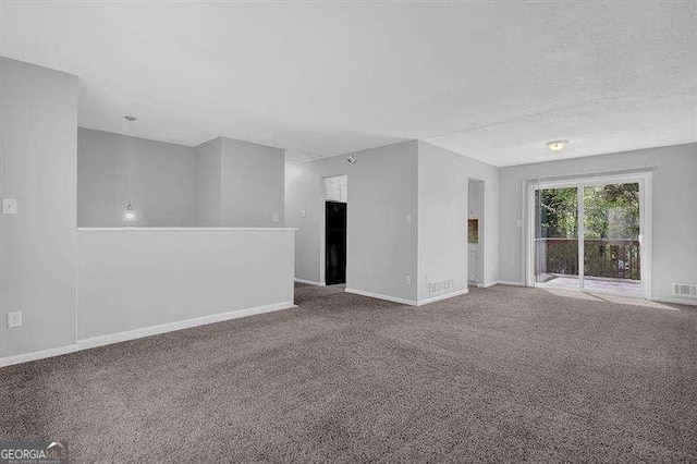 unfurnished room featuring visible vents, baseboards, and carpet floors