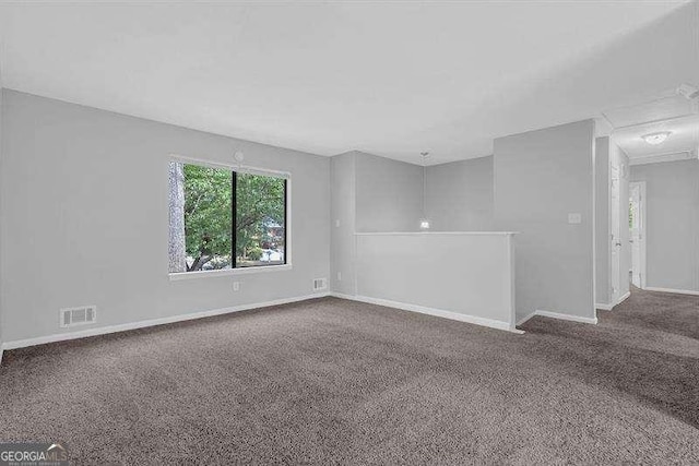unfurnished room with visible vents, baseboards, and carpet flooring