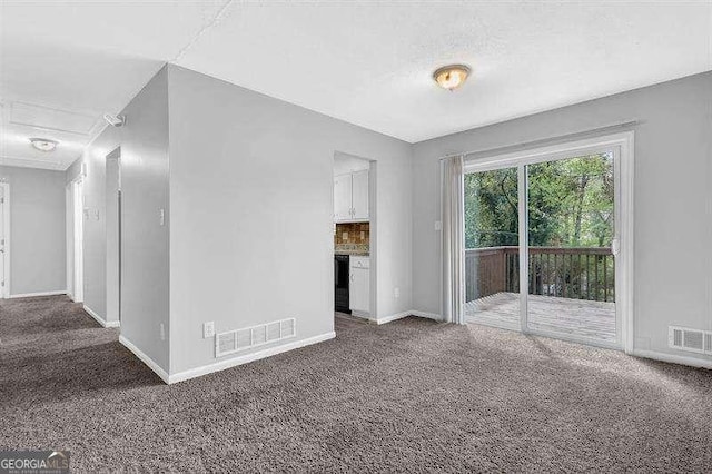 empty room with baseboards, visible vents, and carpet floors