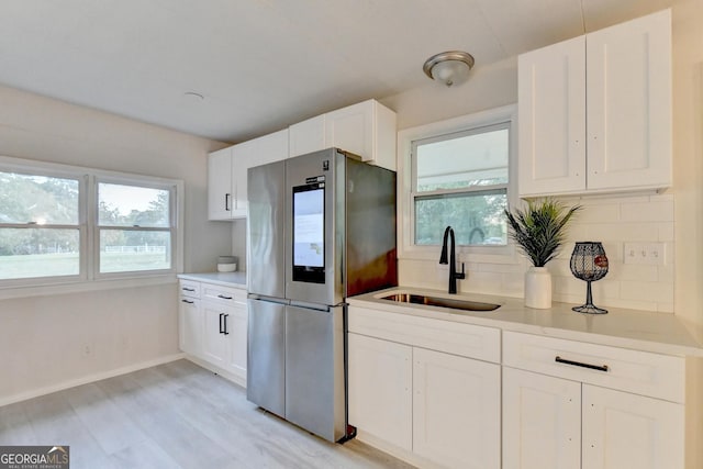 21 W Lake Dr, Oxford, GA 30054 - kitchen with a sink, smart refrigerator, decorative backsplash, and a wealth of natural light