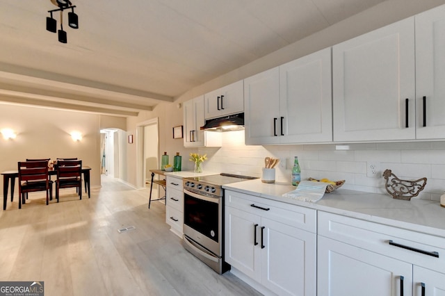 21 W Lake Dr, Oxford, GA 30054 - kitchen featuring tasteful backsplash, white cabinets, under cabinet range hood, stainless steel electric range, and beam ceiling