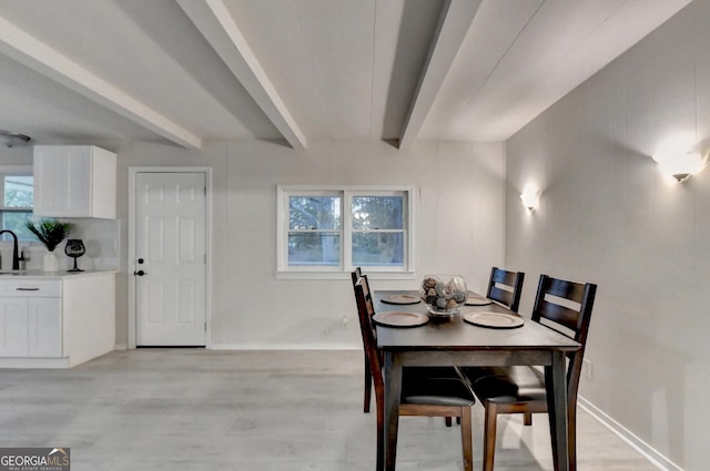 21 W Lake Dr, Oxford, GA 30054 - dining space featuring light wood-style flooring, baseboards, and beamed ceiling