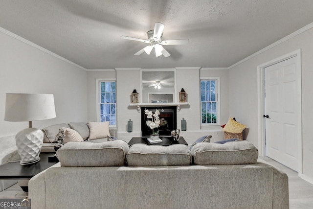 21 W Lake Dr, Oxford, GA 30054 - living room featuring a fireplace with raised hearth, a textured ceiling, ornamental molding, and ceiling fan