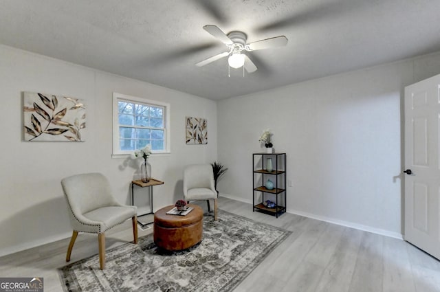 21 W Lake Dr, Oxford, GA 30054 - living area featuring a textured ceiling, baseboards, light wood finished floors, and a ceiling fan