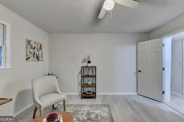 21 W Lake Dr, Oxford, GA 30054 - living area with crown molding, ceiling fan, wood finished floors, and baseboards
