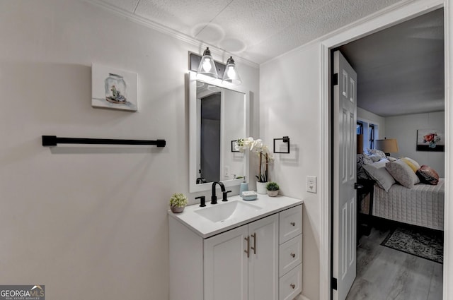 21 W Lake Dr, Oxford, GA 30054 - bathroom with vanity, ensuite bath, a textured ceiling, crown molding, and wood finished floors