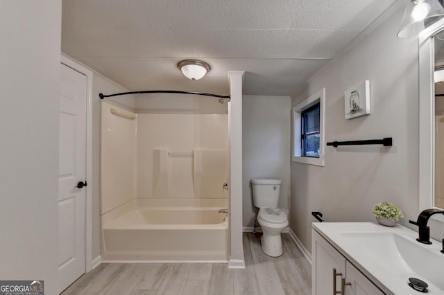 21 W Lake Dr, Oxford, GA 30054 - bathroom with toilet, vanity, wood finished floors, and a textured ceiling