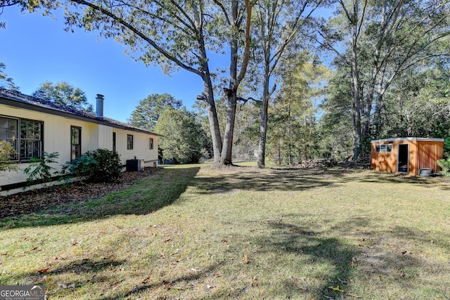 21 W Lake Dr, Oxford, GA 30054 - view of yard featuring an outbuilding, central AC, and a storage unit
