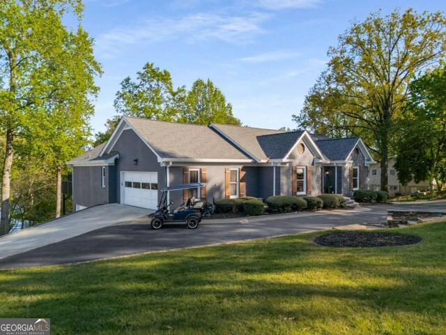 6477 Old Shadburn Ferry Rd, Buford, GA 30518 - ranch-style house featuring a garage, a front yard, asphalt driveway, and stucco siding