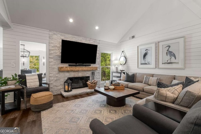 6477 Old Shadburn Ferry Rd, Buford, GA 30518 - living room with wood finished floors, wood walls, a stone fireplace, recessed lighting, and high vaulted ceiling